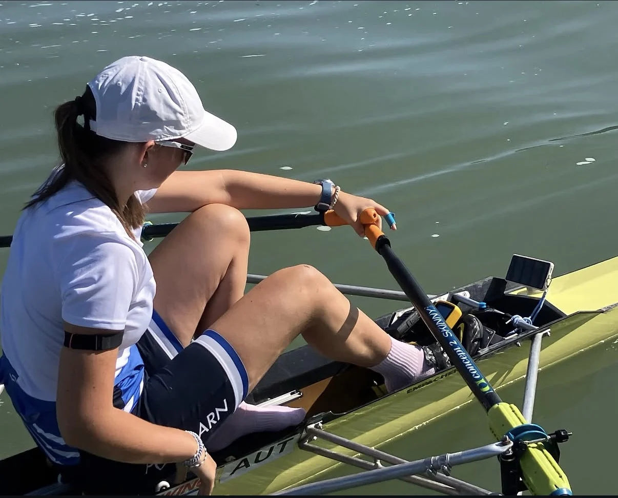 A sculler in a single with ROWPILOT mounted in front of the foot stretcher